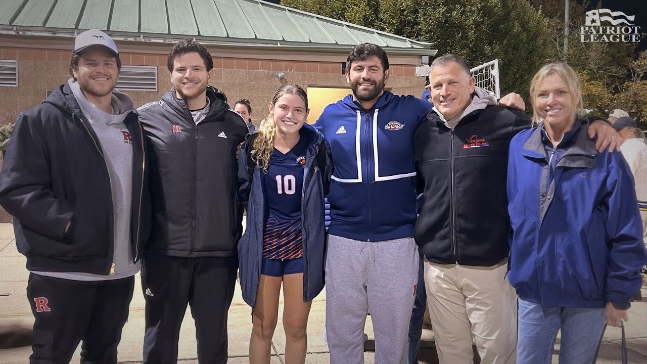 Six people, including a sports uniformed athlete, stand closely together outside. A Patriot League logo appears in the corner.