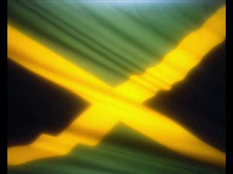 Jamaican flag with a diagonal gold cross, dividing green and black triangles.