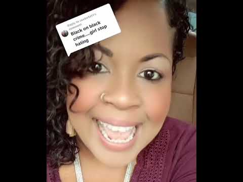 A woman with curly hair, wearing a maroon top, smiles while speaking. A text overlay reads, "Black on black crime...girl stop hating.