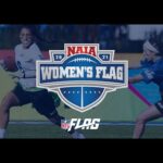 Two women playing flag football, one in a white jersey running with the ball and the other in a blue jersey attempting to grab her flag. NAIA Women's Flag and NFL Flag logos are visible.