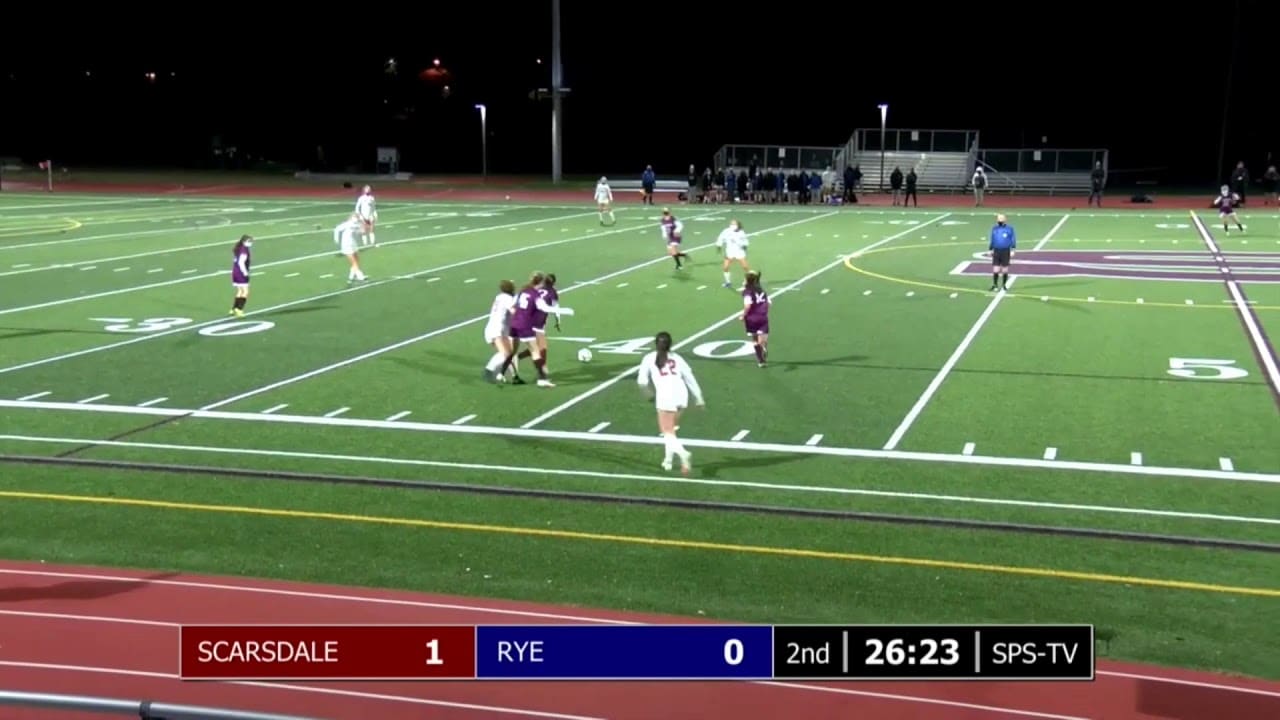 Girls' soccer match between Scarsdale and Rye with a scoreboard showing 1-0; Scarsdale leads. The game is in the second half with 26:23 remaining.